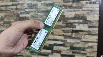 A person holding a 32GB ECC DDR4 RAM stick