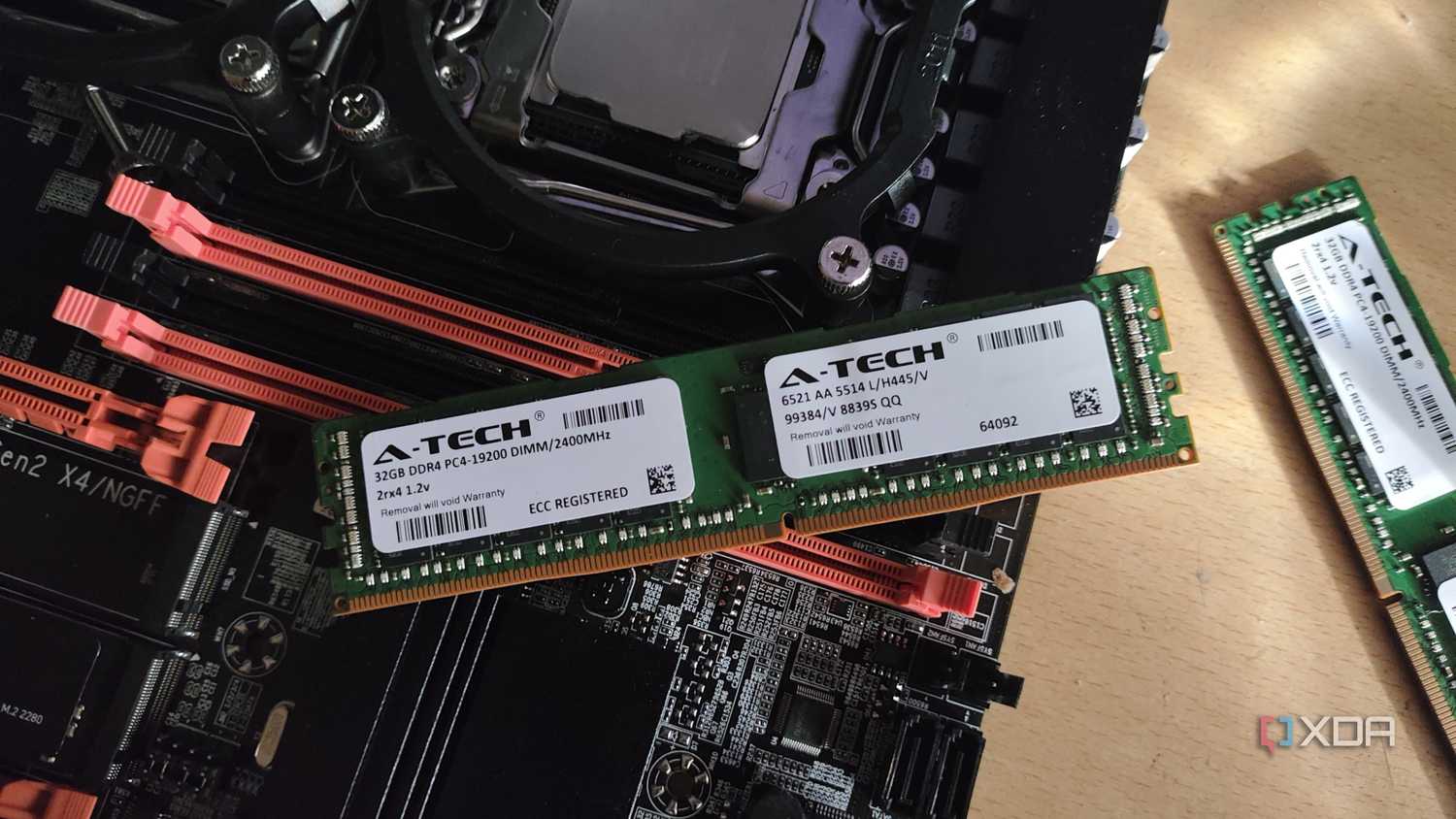 A 32GB ECC RAM stick resting on an X99 server motherboard