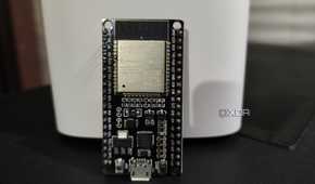 An ESP32 resting against a D-Link mesh router