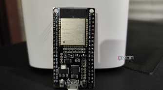 An ESP32 resting against a D-Link mesh router