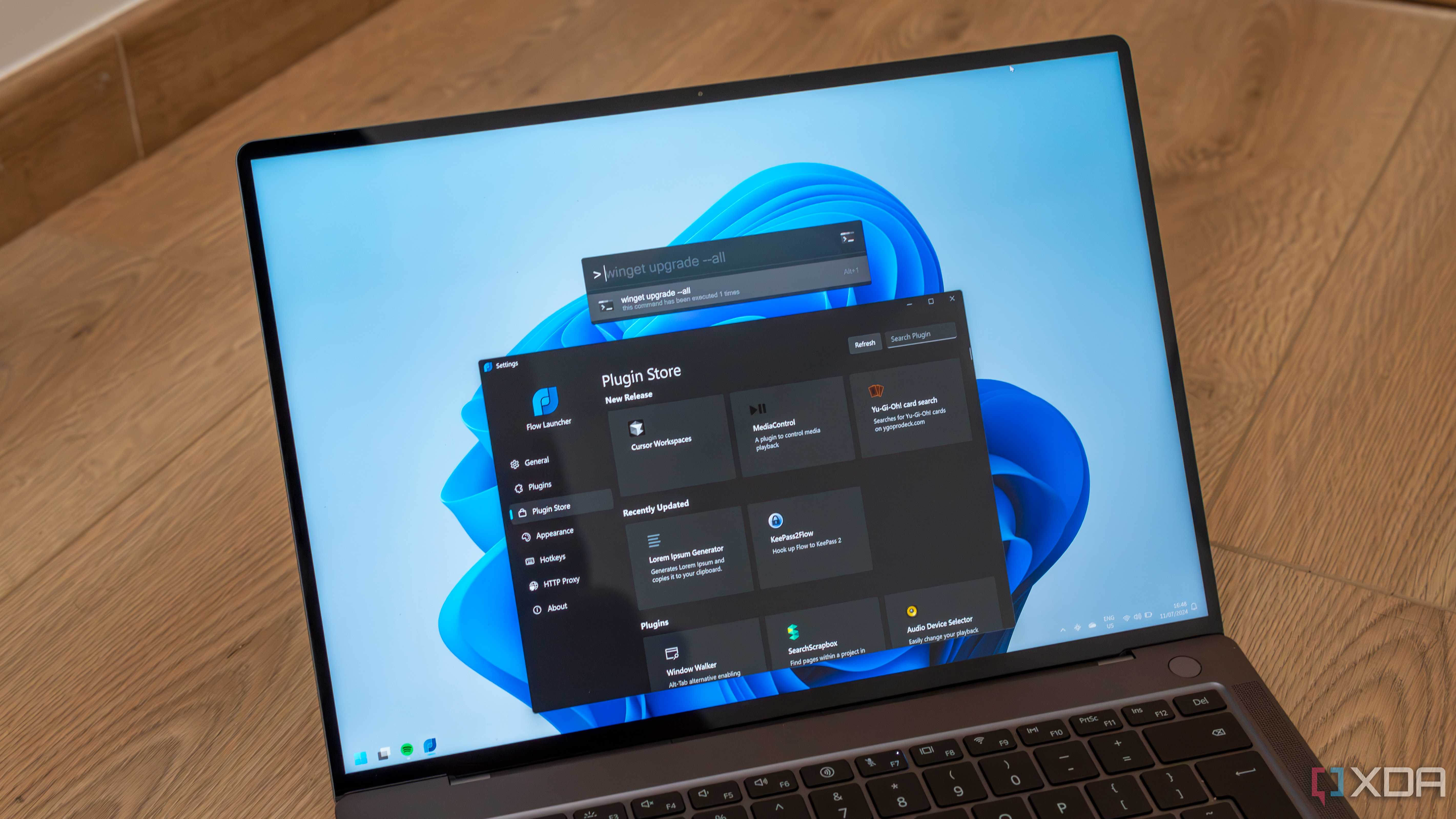 A Windows 11 laptop showing Flow launcher settings and the search bar