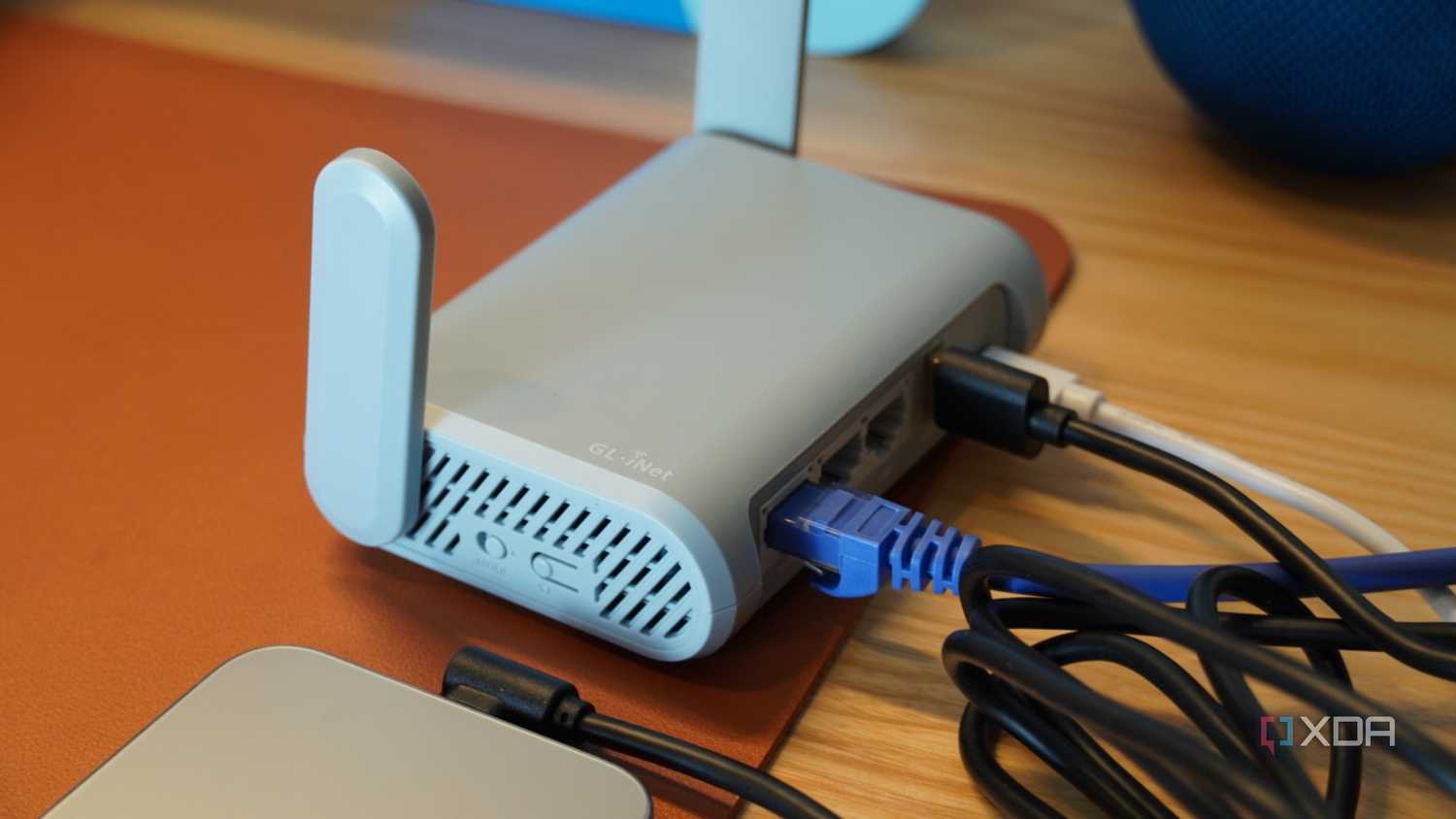 An iPhone connected to a travel router.