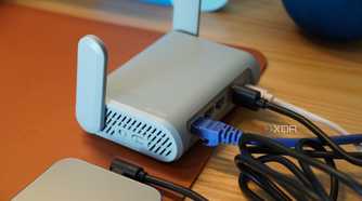 An iPhone connected to a travel router.