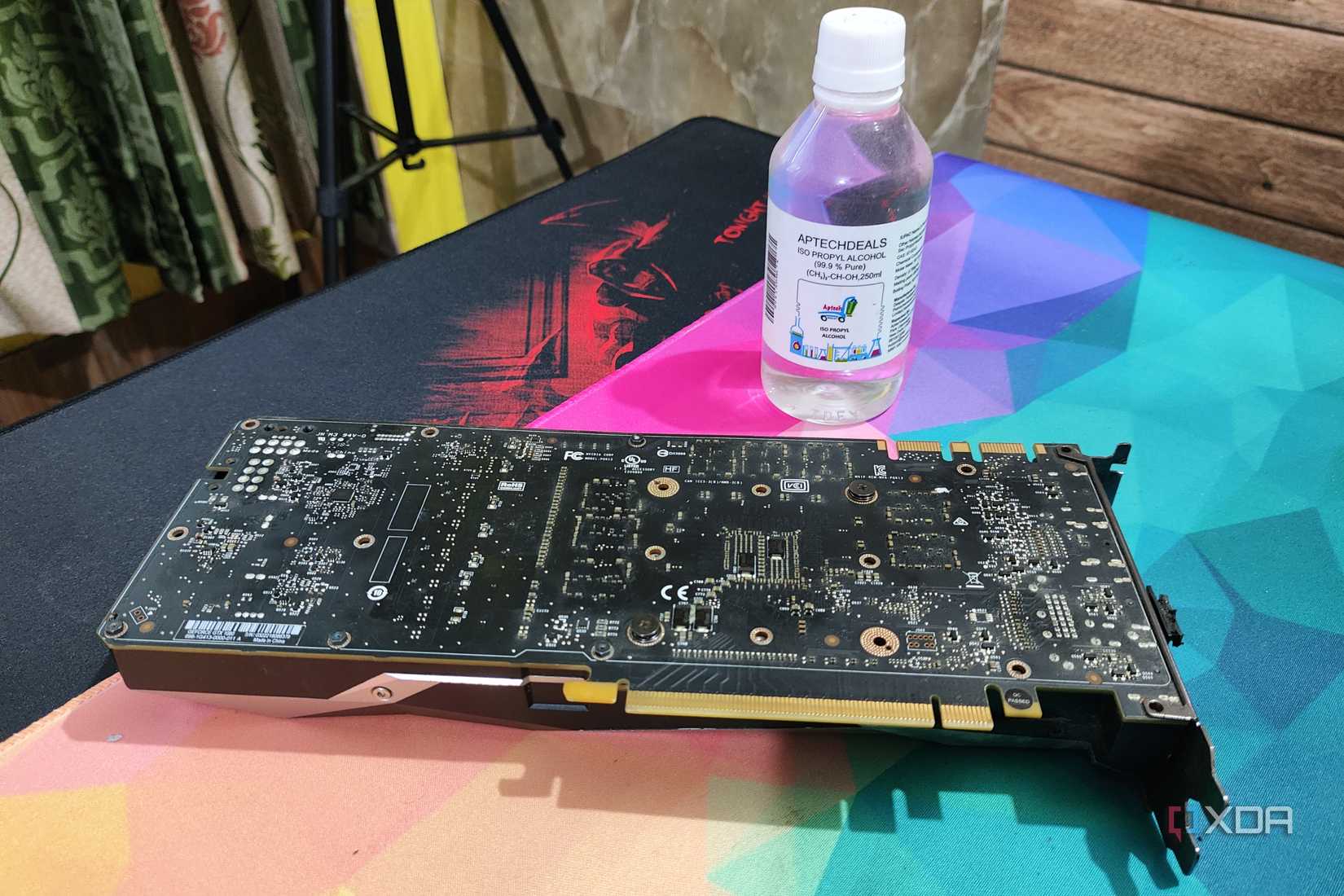A bottle of isopropyl alcohol with a GTX 1080 kept nearby