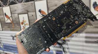 A person holding a GTX 1080 without its backplate