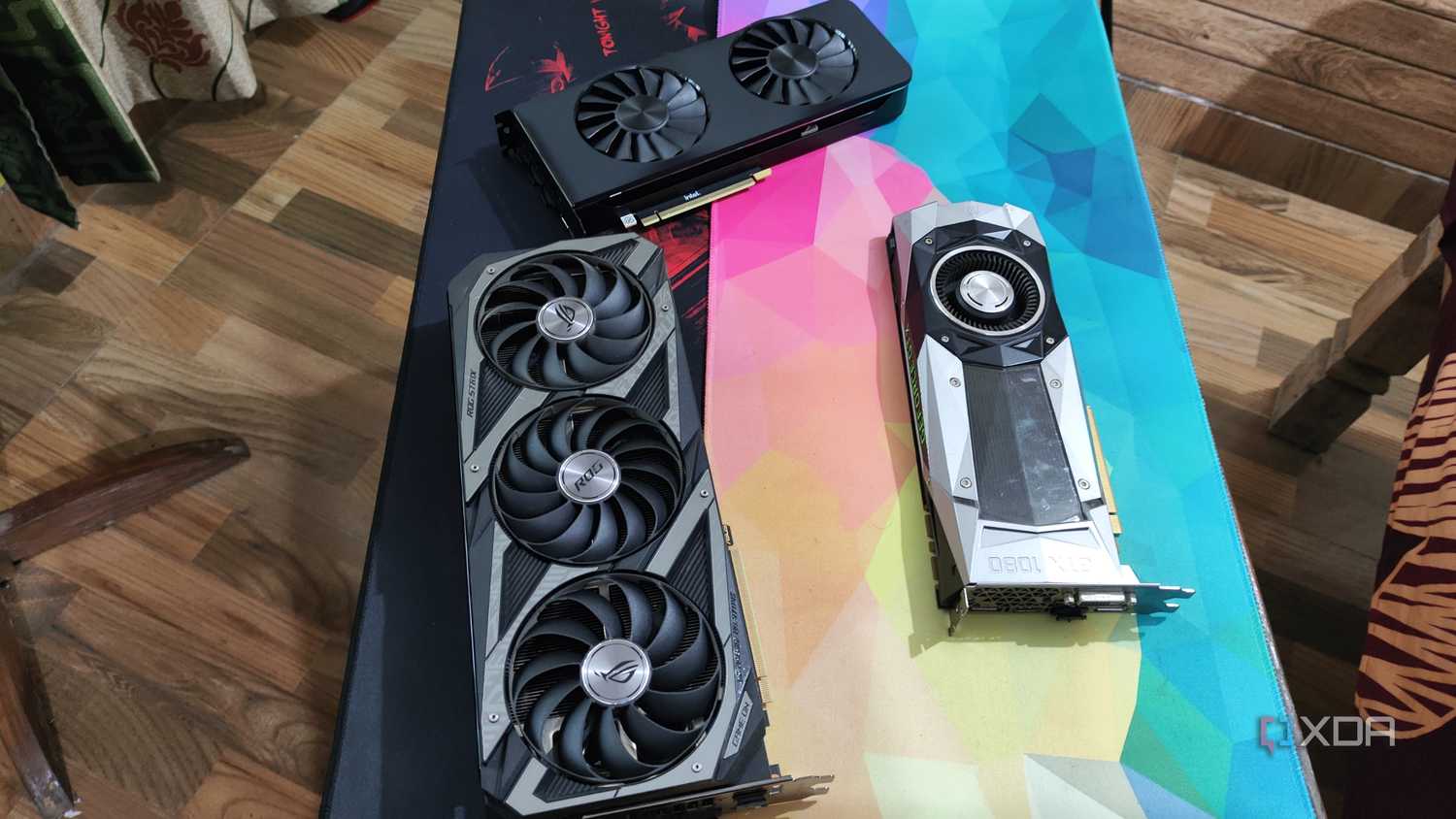 An Intel Arc A750 placed next to an ASUS Rog Strix RTX 3080 Ti and a GTX 1080 Ti