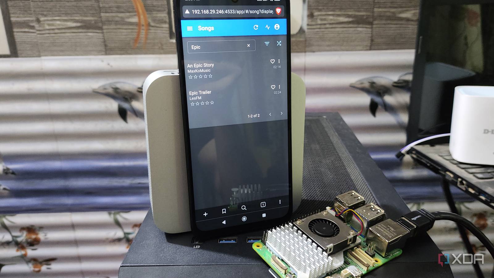 The Navidrome web UI running on a Poco M6 Pro, with a Raspberry Pi 5 lying nearby