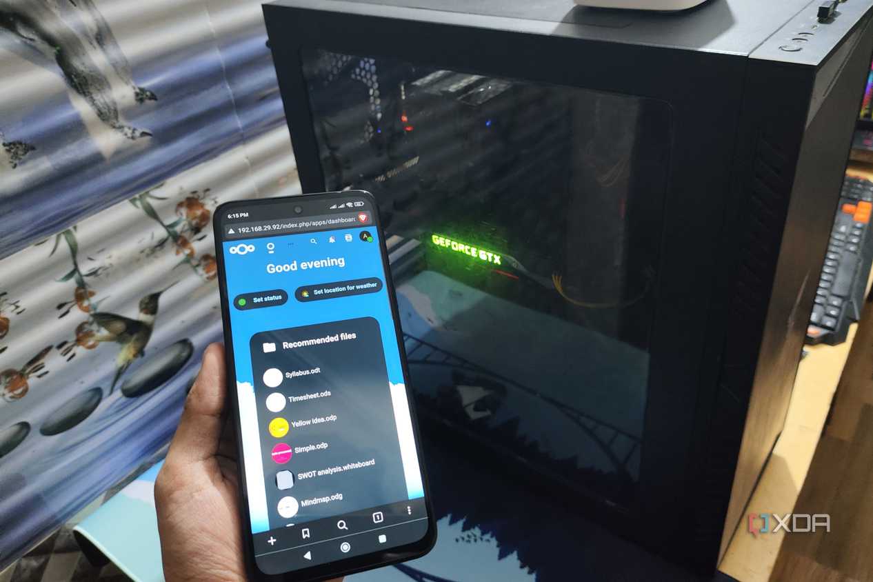 The Nextcloud UI displayed on a Poco M6 Pro, with a PC in the background