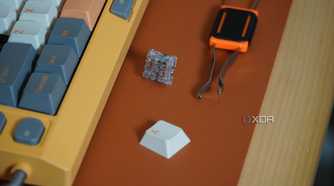 A keycap/switch puller beside the NuPhy Field75 keyboard.