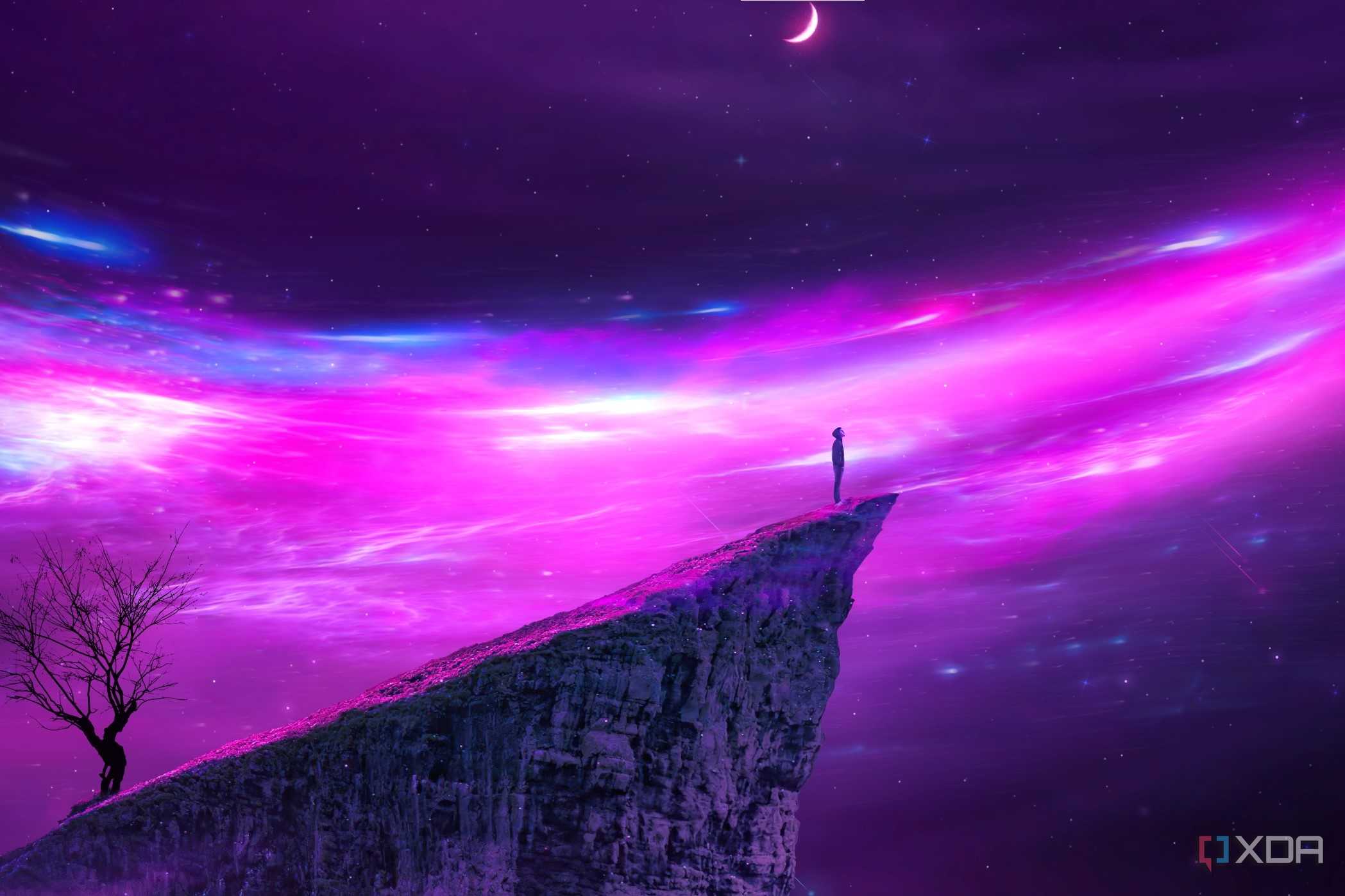 A wallpaper showing a person standing on the edge of a cliff looking at a purple universe