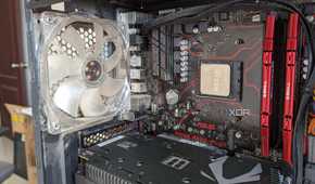Close-up of the inside of a gaming PC showing the CPU, GPU, motherboard, and RAM