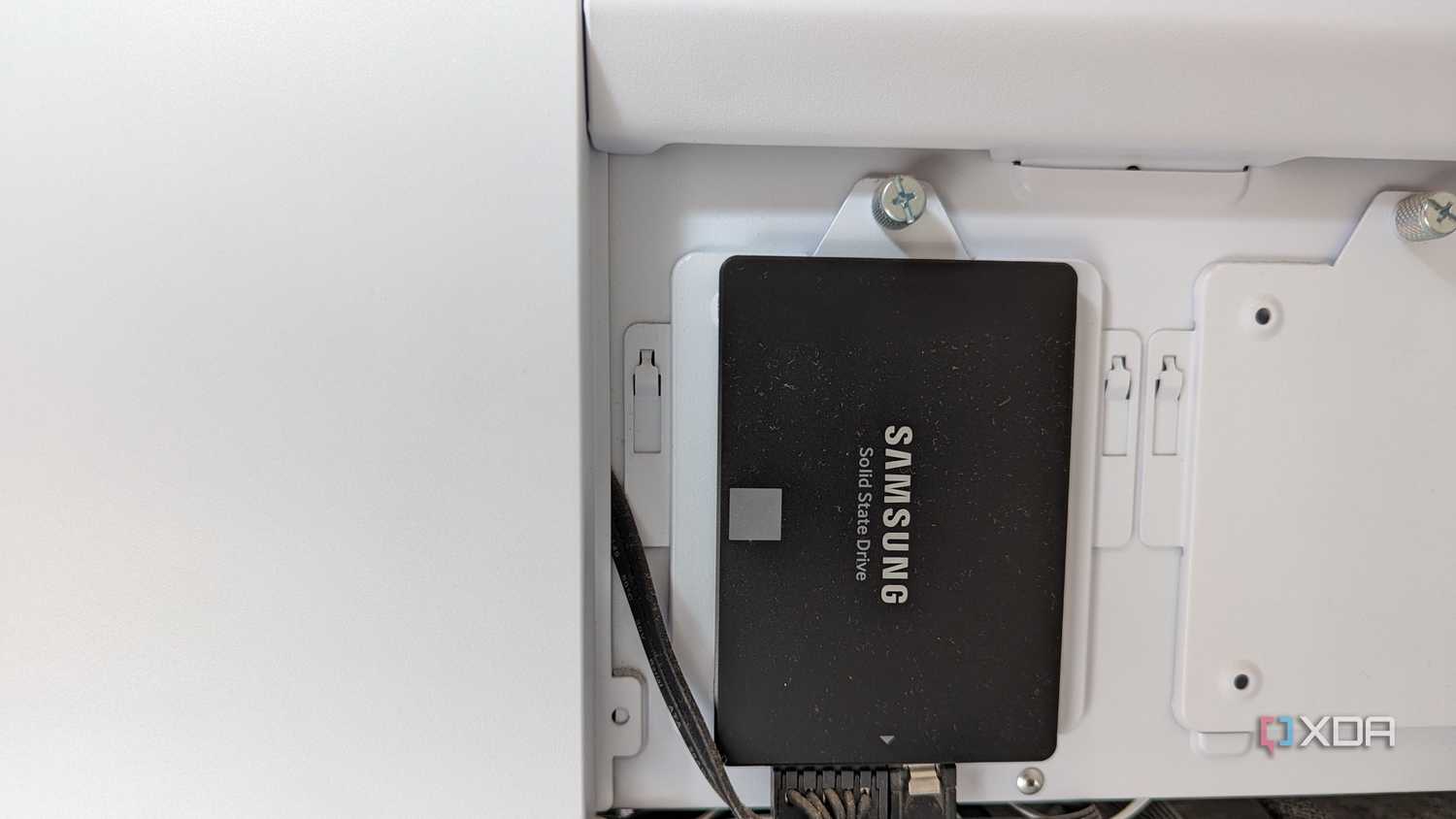 Samsung 860 EVO 250GB SSD in black installed on a white case