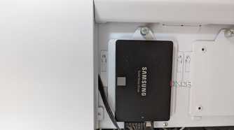 Samsung 860 EVO 250GB SSD in black installed on a white case
