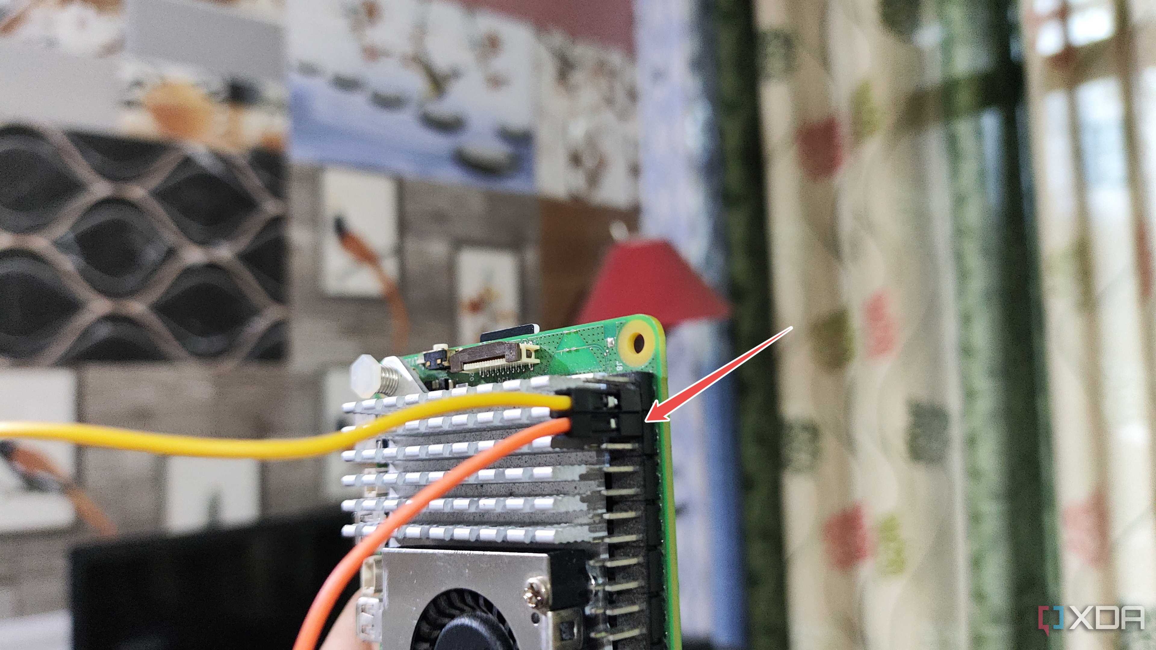 Plugging the jumper cable into the Raspberry Pi 5's GND pin