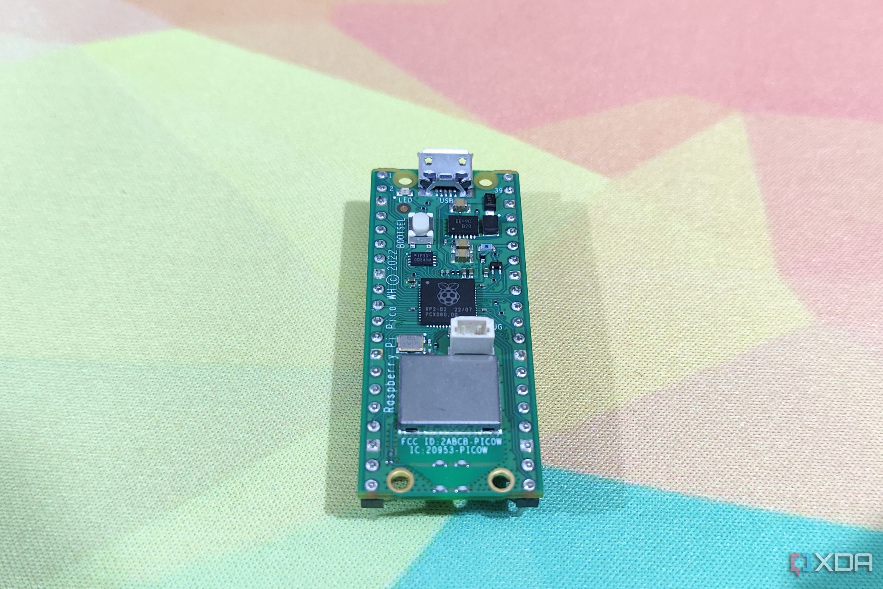 A Raspberry Pi Pico lying on a mousepad