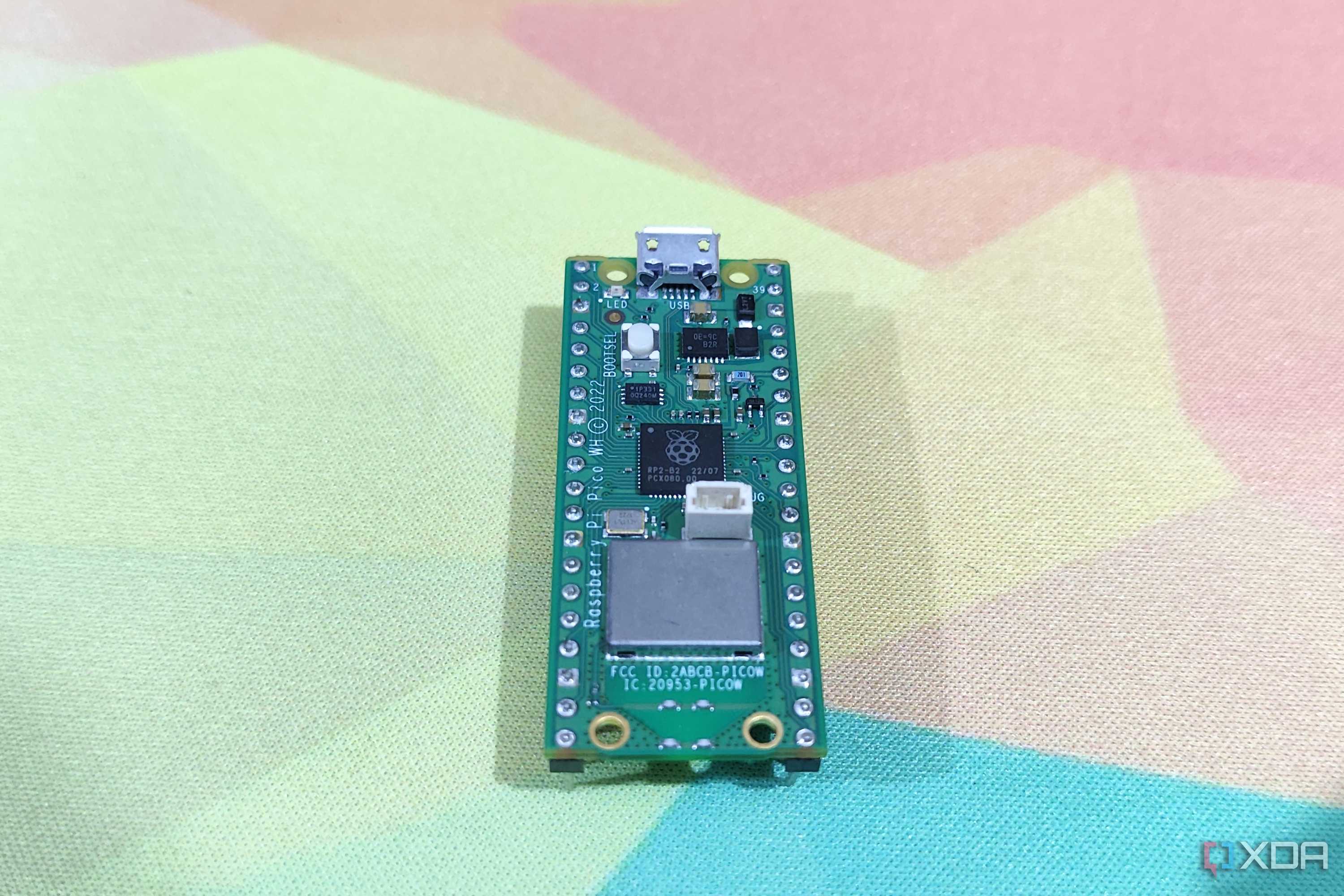 A Raspberry Pi Pico lying on a mousepad