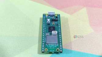 A Raspberry Pi Pico lying on a mousepad