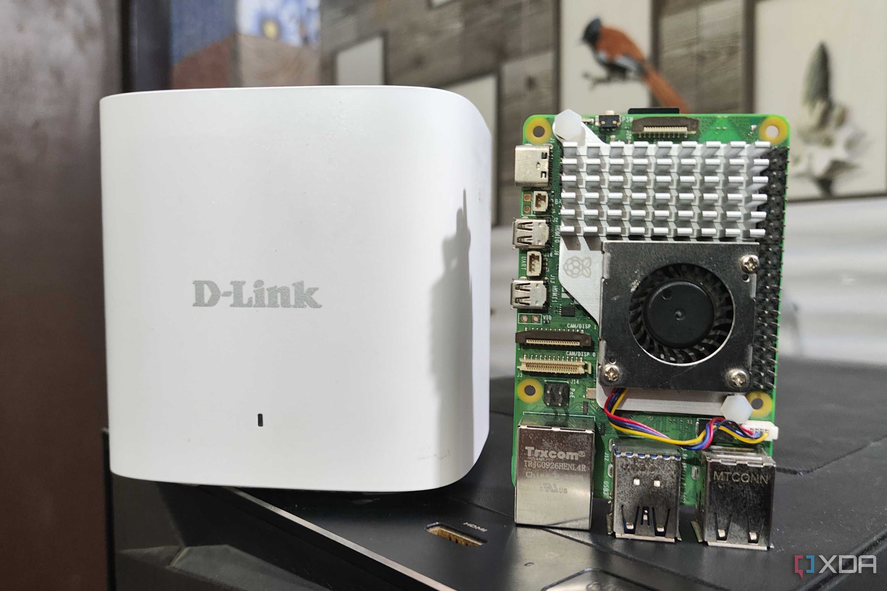 A Raspberry Pi 5 placed next to a D-Link Eagle Pro mesh router