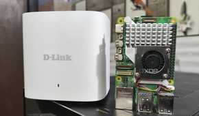 A Raspberry Pi 5 placed next to a D-Link Eagle Pro mesh router