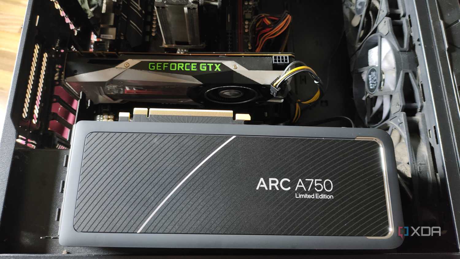 An Intel Arc A750 resting on a case containing a GTX 1080