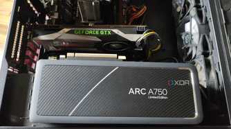 An Intel Arc A750 resting on a case containing a GTX 1080