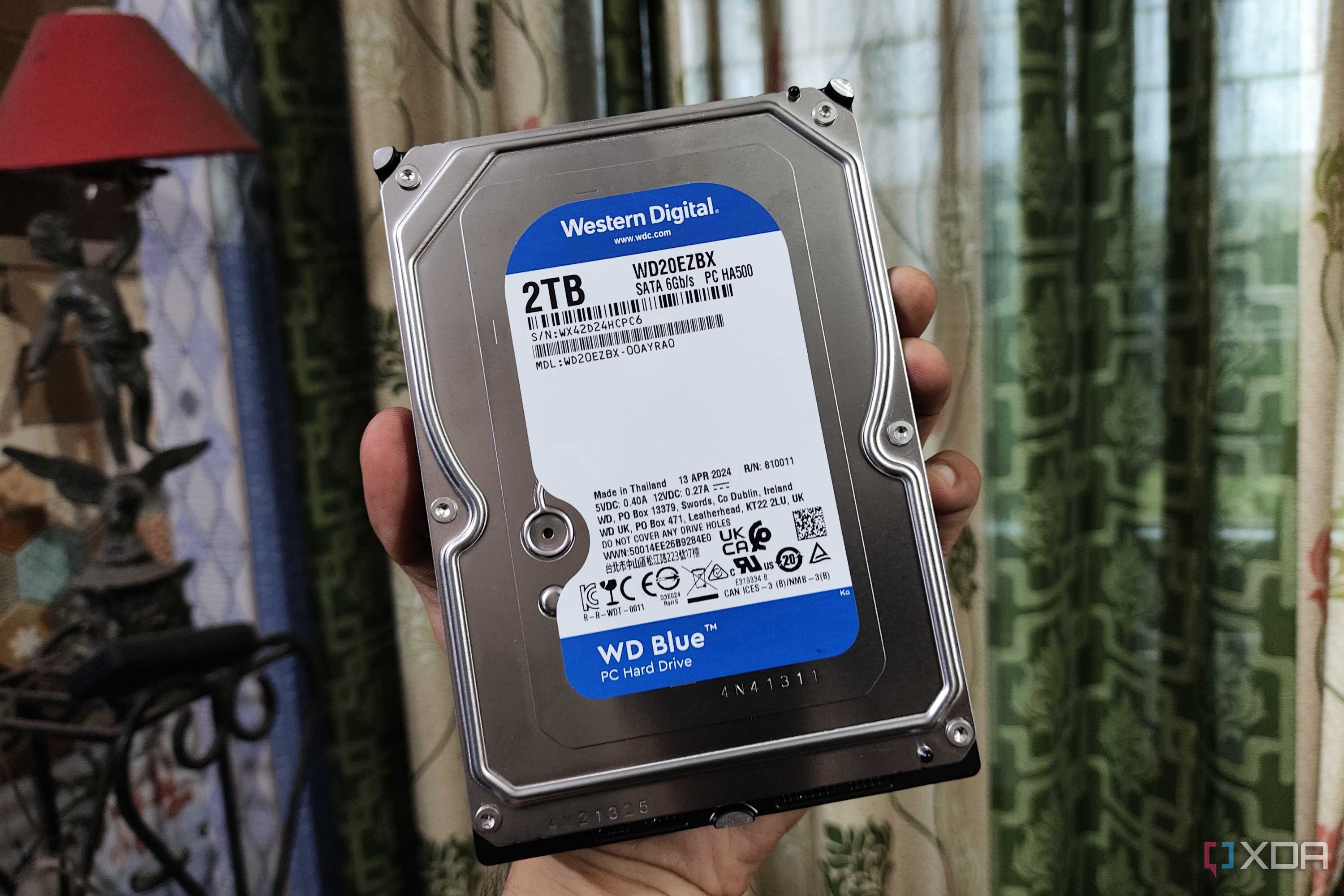 A person holding a WD Blue HDD