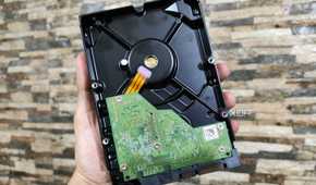 A person holding a WD Blue HDD