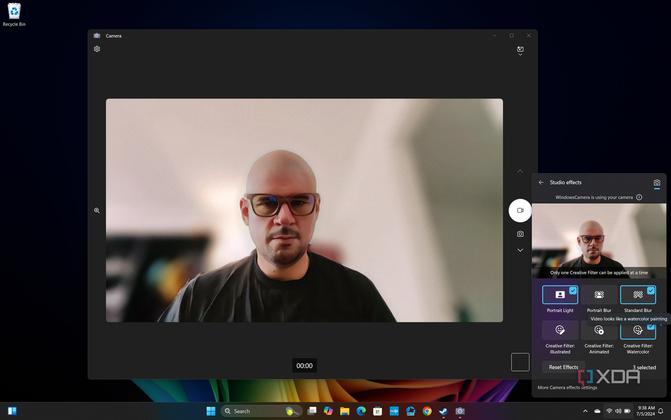 Screenshot of Windows 11 desktop previewing Windows Studio effects in Quick settings, with Portrait light, Standard blur, and a Watercolor filter applied