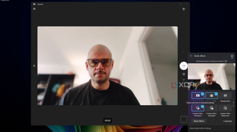 Screenshot of Windows 11 desktop previewing Windows Studio effects in Quick settings, with Portrait light, Portrait blur, and a Illustrated filter applied
