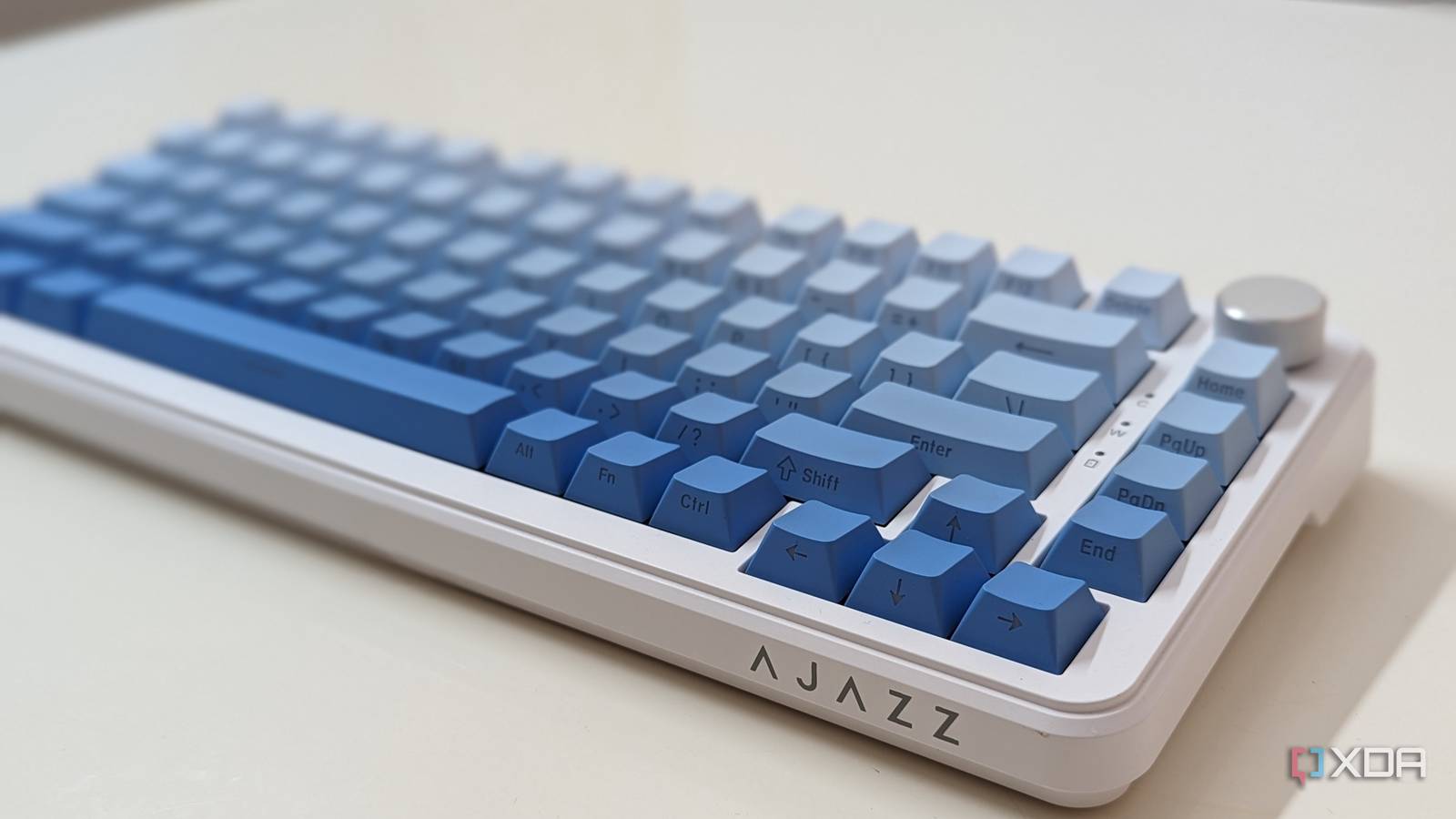 Close-up of a blue-white mechanical keyboard on a white surface