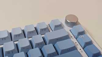 Close-up of a blue-white keyboard showing a metal knob