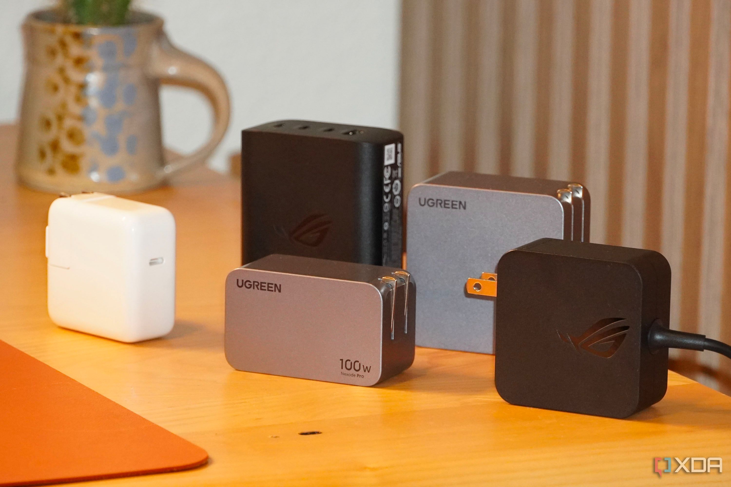 The group of power adapters on a desk.