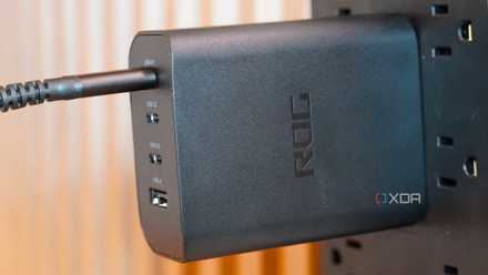 The Asus ROG 140W charger is connected to the power strip.