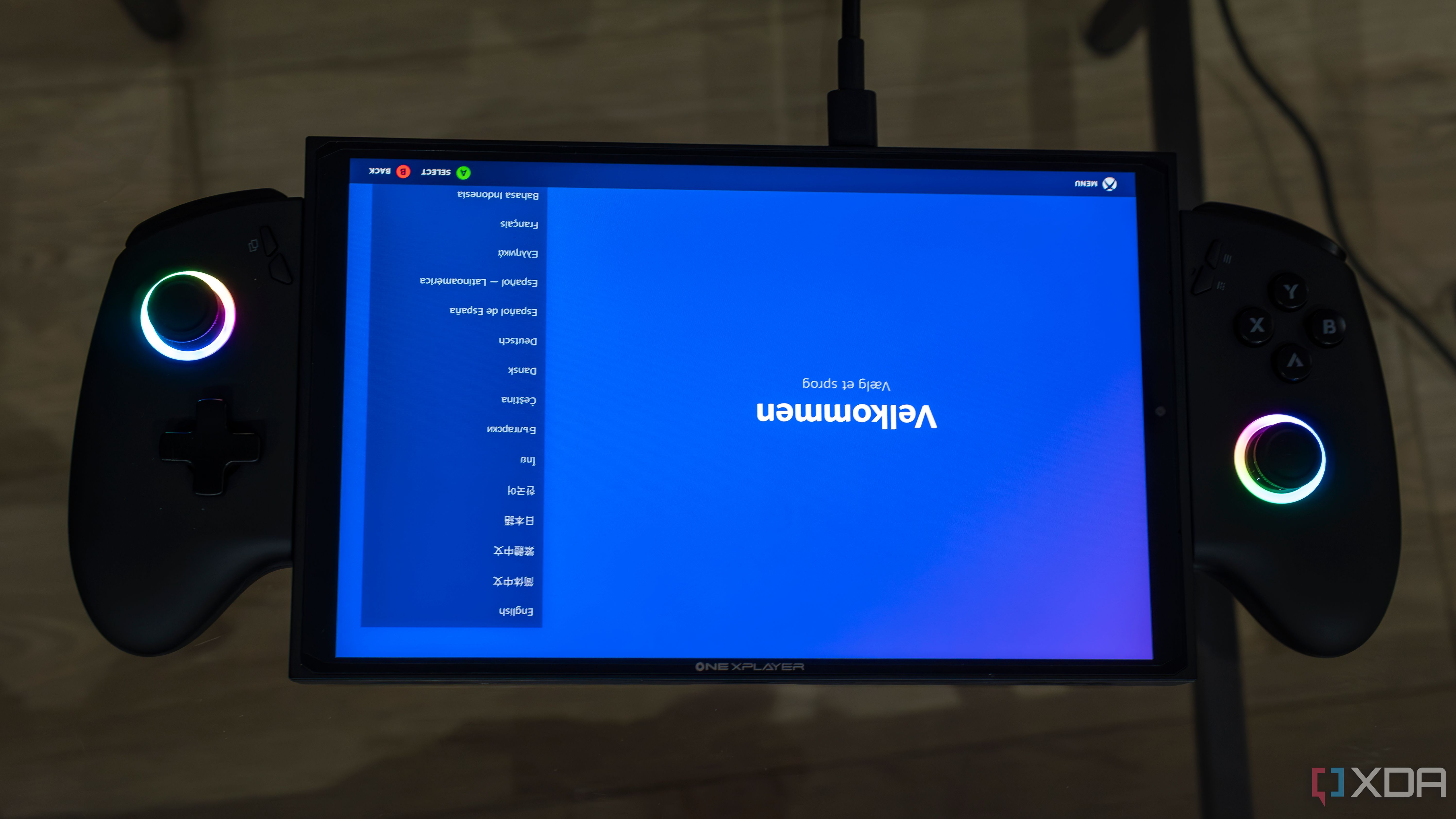 A ONEXPLAYER X1 Mini gaming handheld displaying the welcome screen for the Steam gaming UI upside down