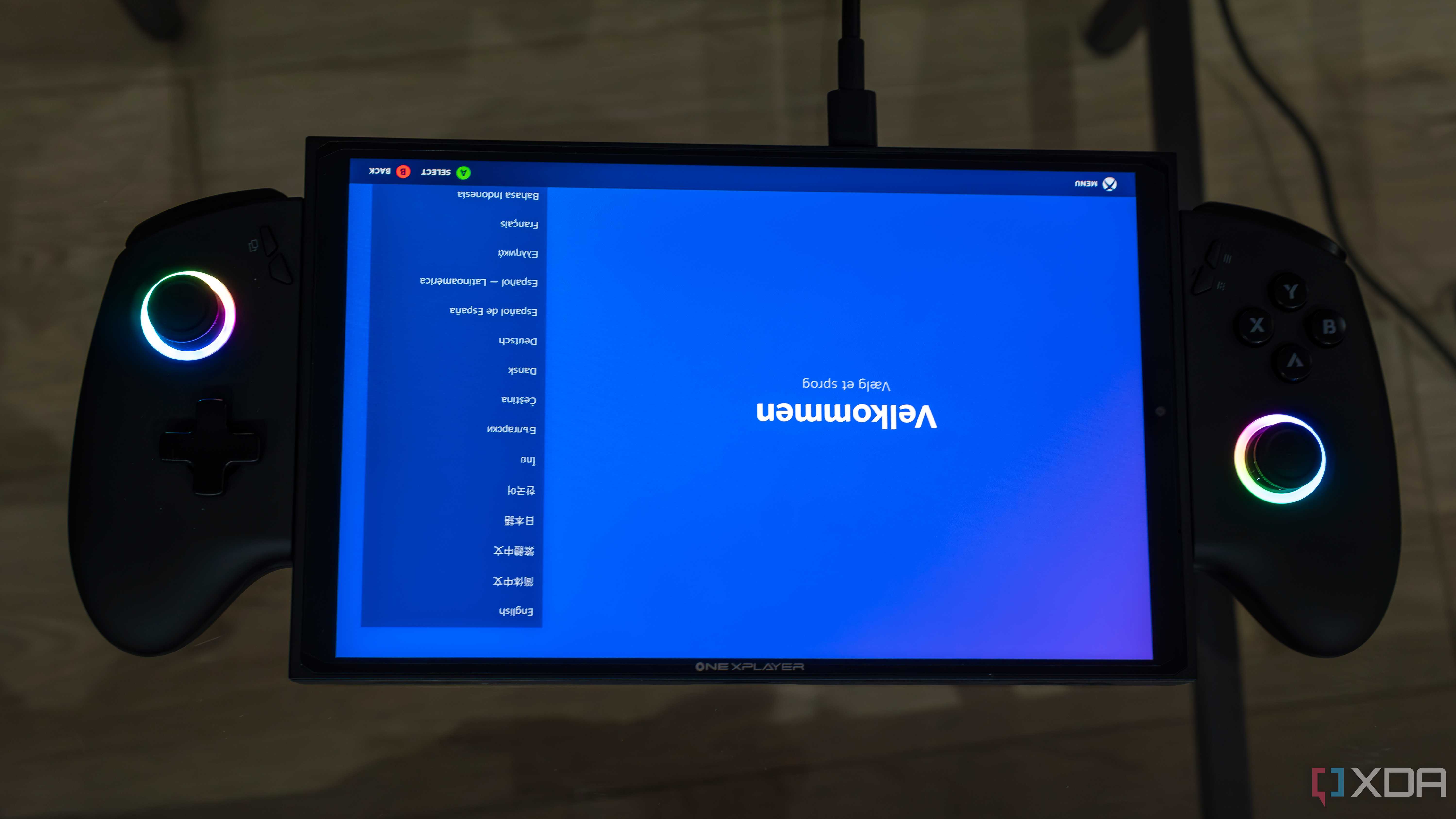A ONEXPLAYER X1 Mini gaming handheld displaying the welcome screen for the Steam gaming UI upside down