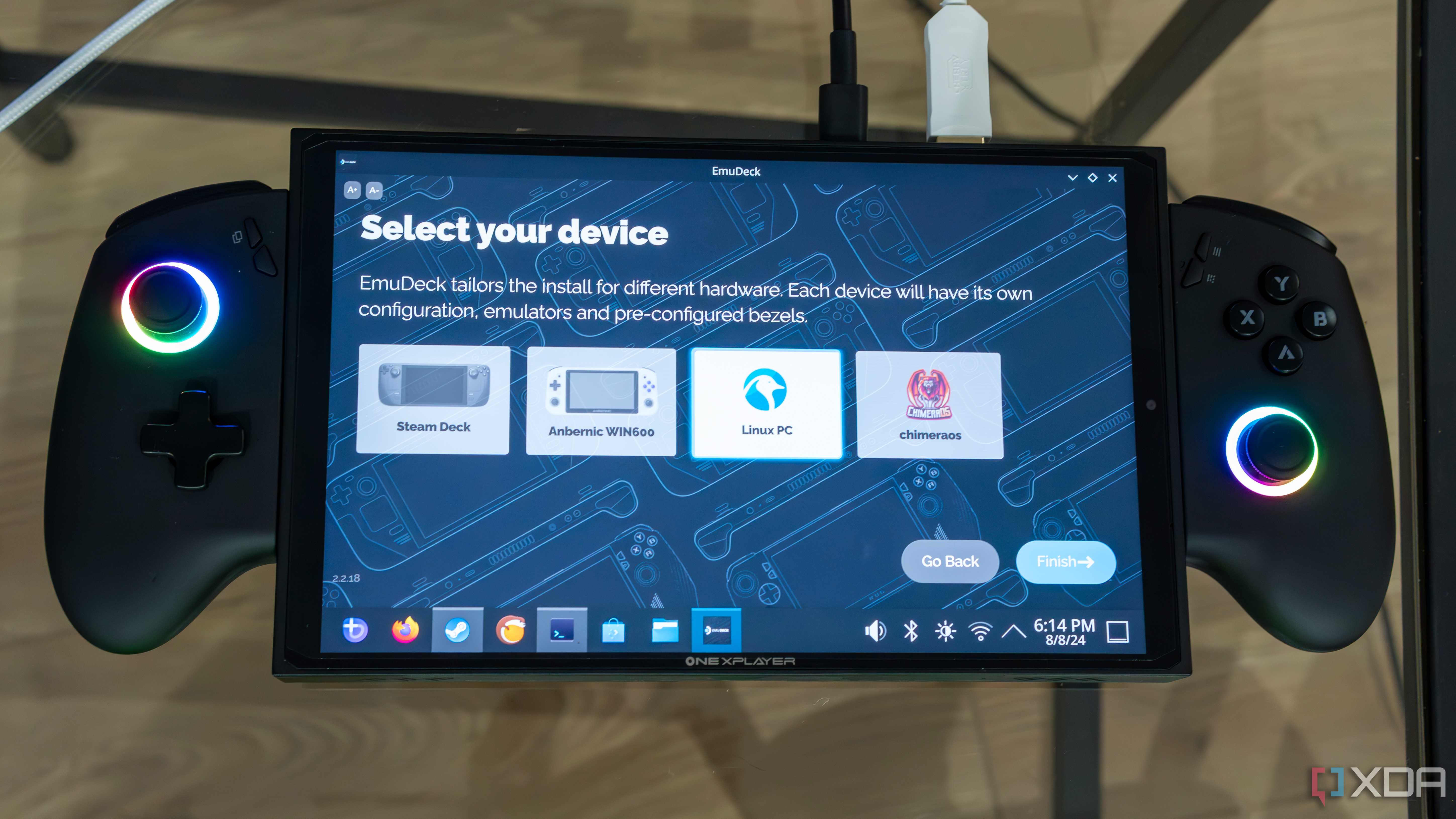 A ONEXPLAYER X1 Mini gaming handheld displaying the setup process for EmuDeck, asking the user what device is being used