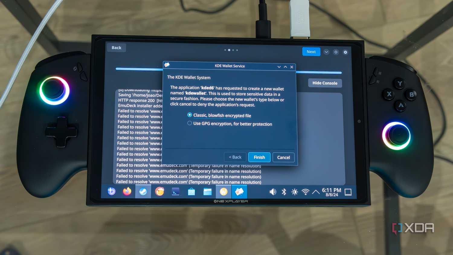 A ONEXPLAYER X1 Mini gaming handheld running Bazzite, displaying a message asking the user what kind of encryption they want to use for the KDE Wallet System