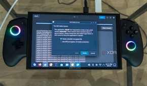 A ONEXPLAYER X1 Mini gaming handheld running Bazzite, displaying a message asking the user what kind of encryption they want to use for the KDE Wallet System