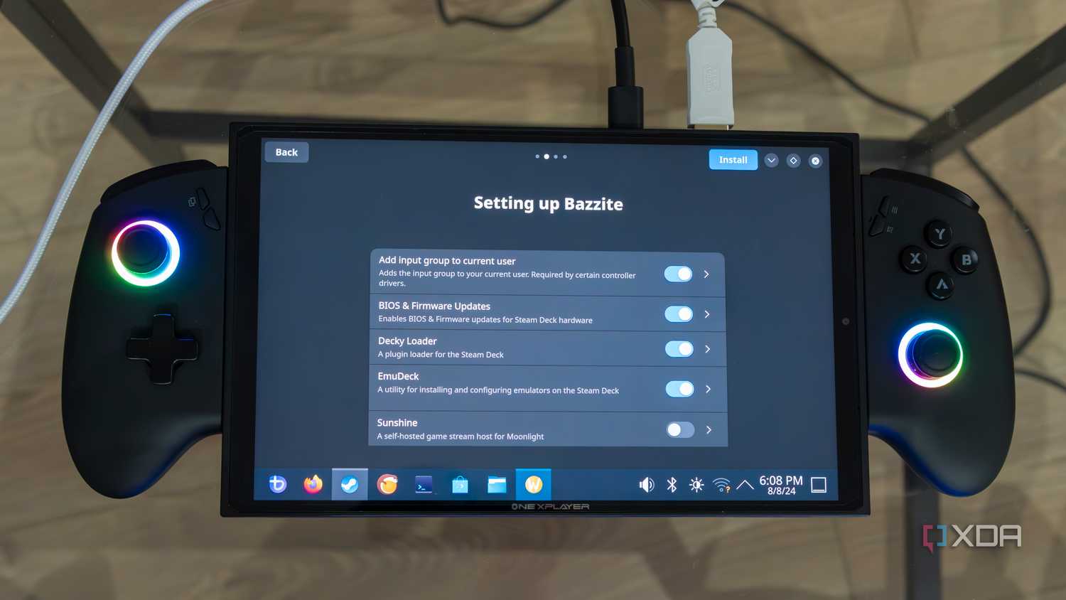 A ONEXPLAYER X1 Mini gaming handheld displaying the Bazzite setup screen with a list of things the user can choose to install