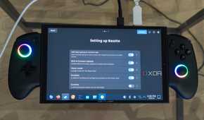 A ONEXPLAYER X1 Mini gaming handheld displaying the Bazzite setup screen with a list of things the user can choose to install