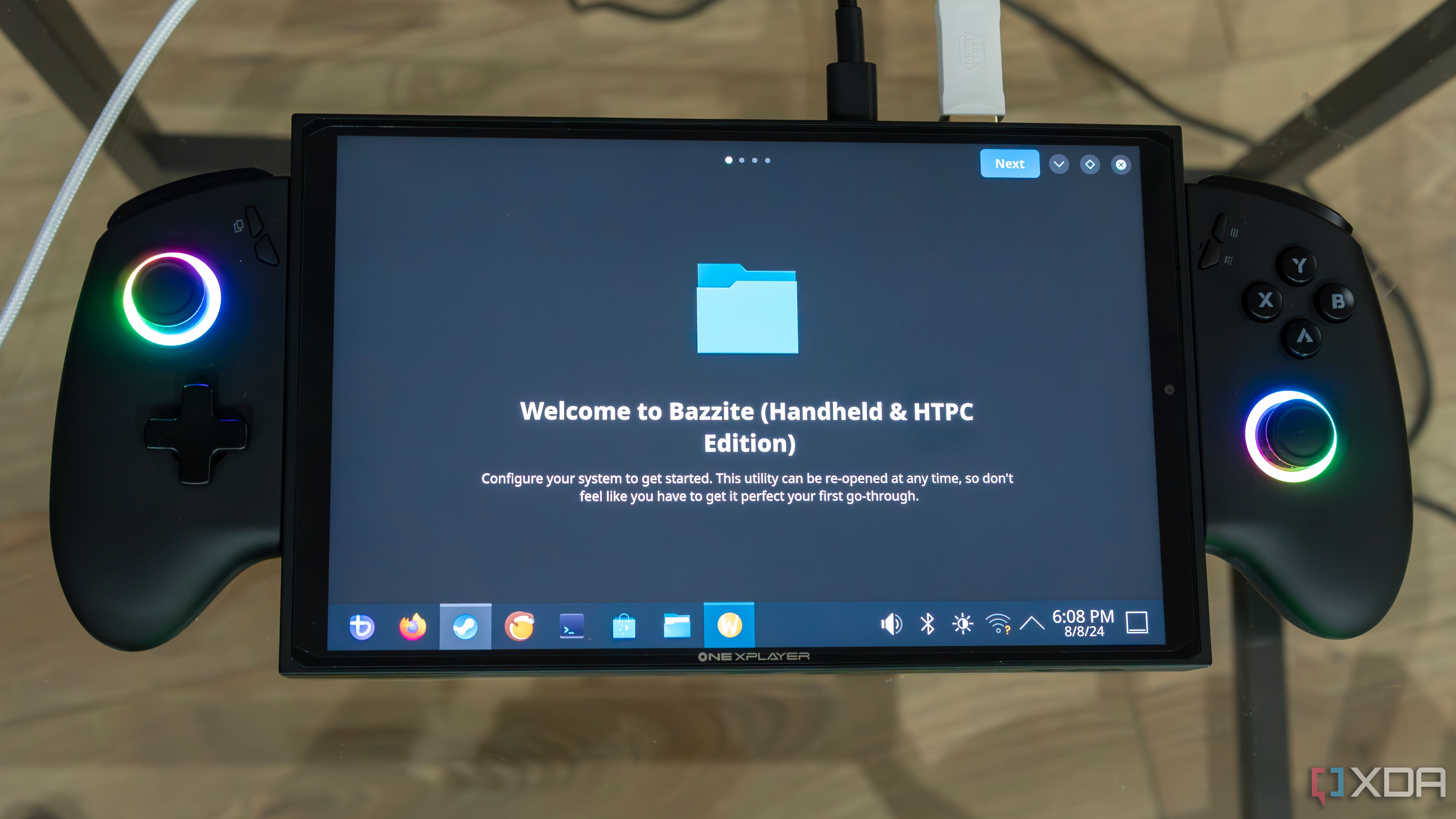 A ONEXPLAYER X1 Mini gaming handheld displaying the first-time welcoming experience on the KDE desktop