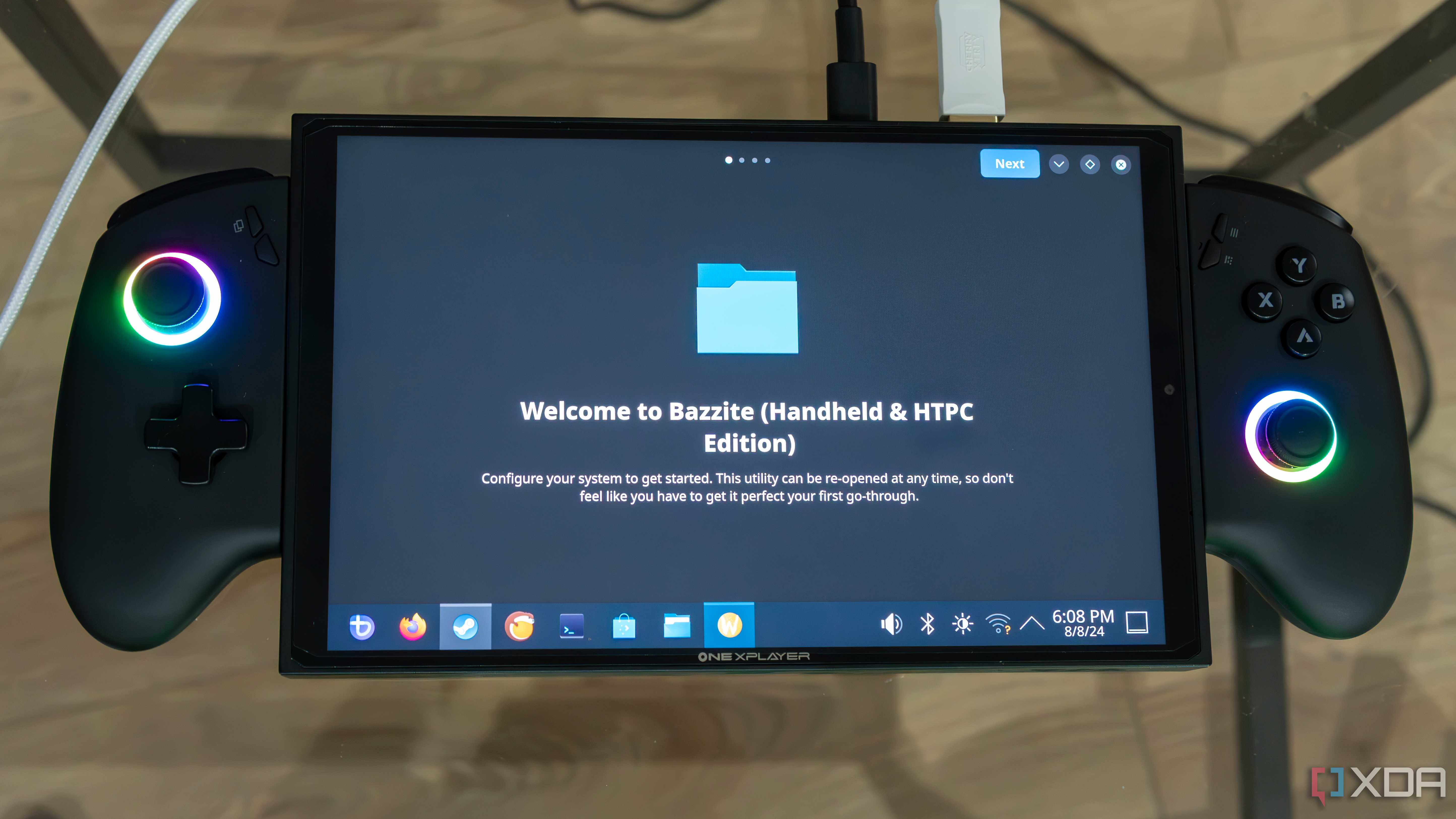 A ONEXPLAYER X1 Mini gaming handheld displaying the first-time welcoming experience on the KDE desktop