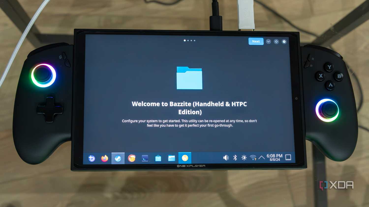 A ONEXPLAYER X1 Mini gaming handheld displaying the first-time welcoming experience on the KDE desktop