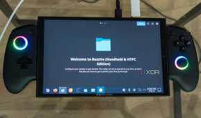 A ONEXPLAYER X1 Mini gaming handheld displaying the first-time welcoming experience on the KDE desktop