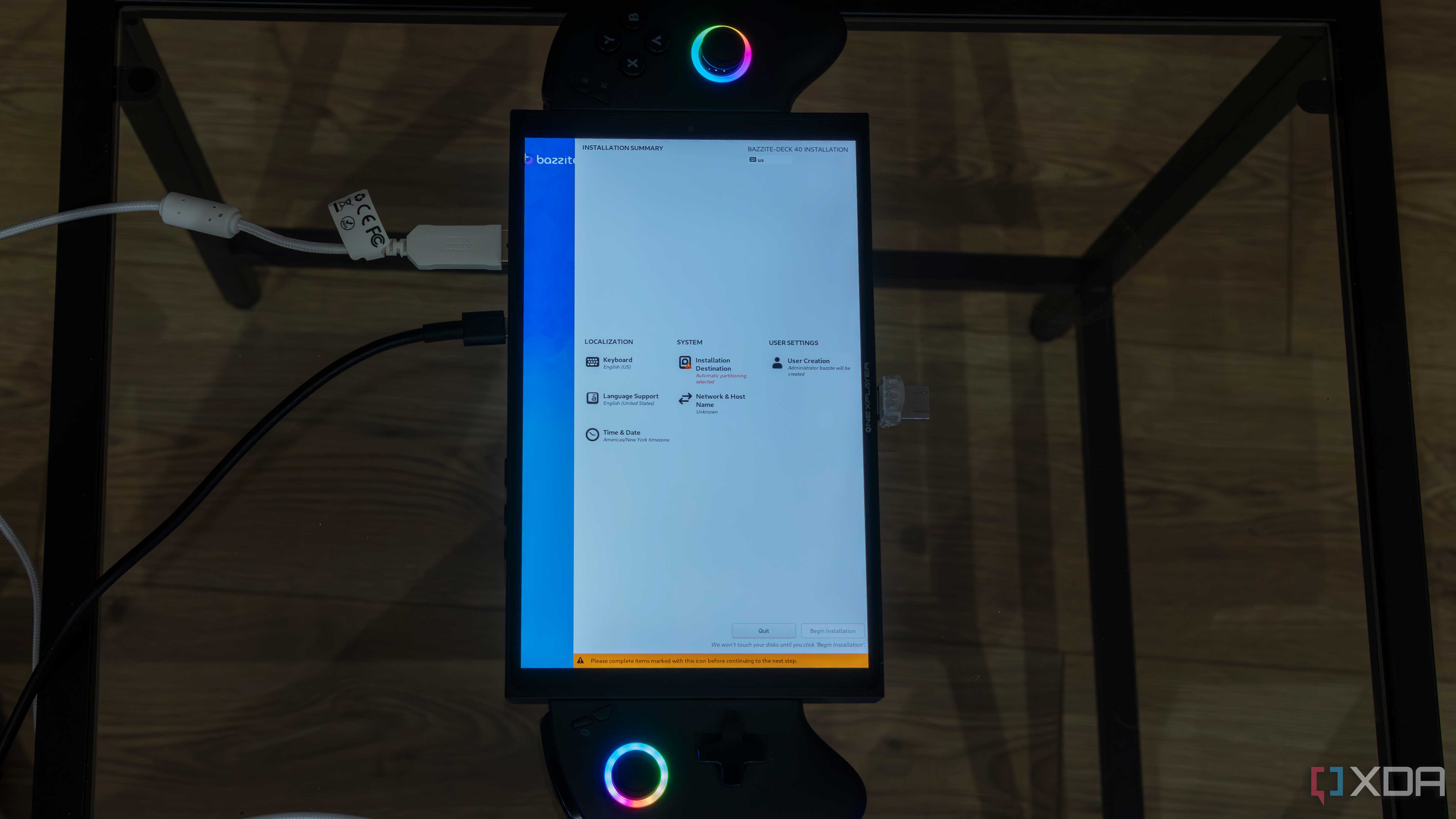 A ONEXPLAYER X1 Mini gaming handheld displaying the setup settings for Bazzite before beginning installation
