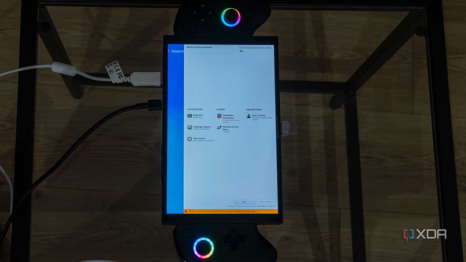 A ONEXPLAYER X1 Mini gaming handheld displaying the setup settings for Bazzite before beginning installation