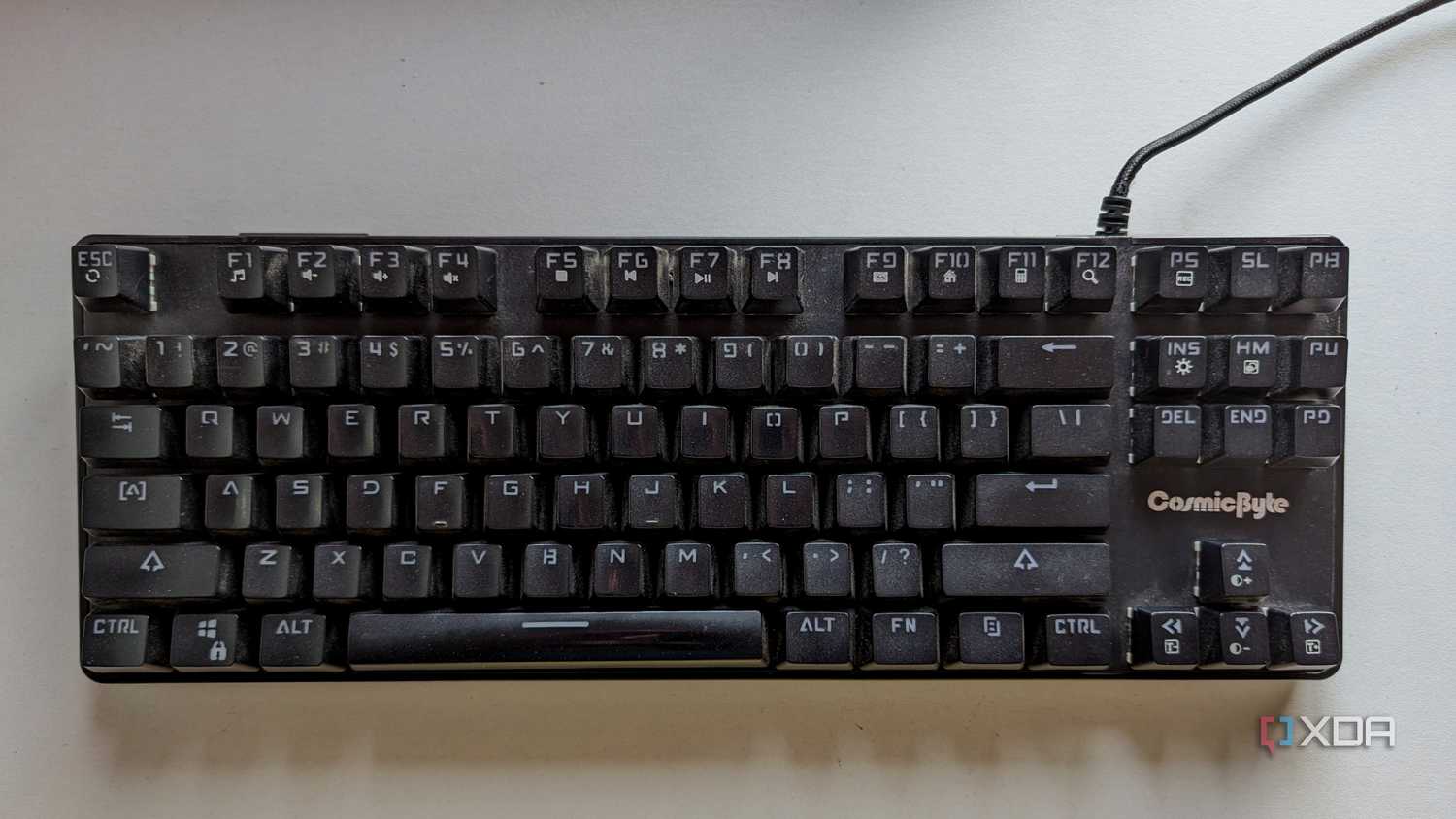 A black wired mechanical keyboard on a white surface