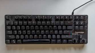 A black wired mechanical keyboard on a white surface
