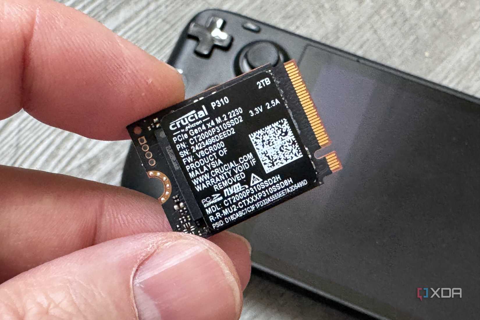 crucial p310 ssd held in fingers