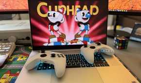 razer blade 18 gaming laptop playing cuphead with two xbox controllers on top of the keyboard